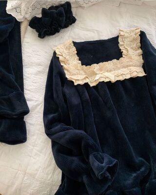 Vintage pyjama set with black lace on the bed