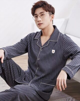 Beige striped white cotton summer pajamas with folded collar for men worn by a man sitting on a carpet in a house