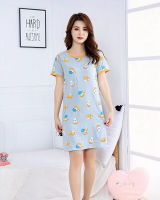 Short grey nightgown with shiba dog print worn by a woman in a house