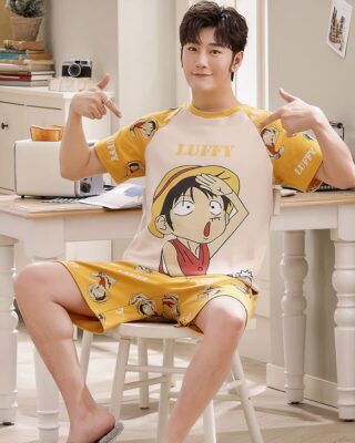 Summer pajama set t-shirt and shorts man with Luffy print very high quality worn by a man sitting on a chair in a house