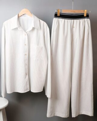 Black striped white cotton long sleeve pajamas for woman worn by a woman on a belt