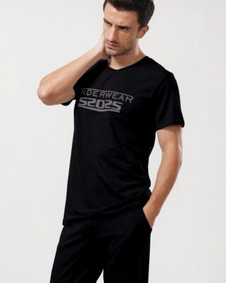 Fashionable men's black cotton two-piece pajamas worn by a fashionable man