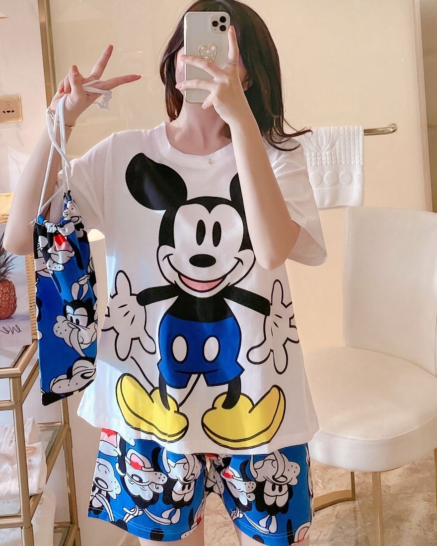 Mickey Mouse printed satin summer pajama set worn by a woman in a house