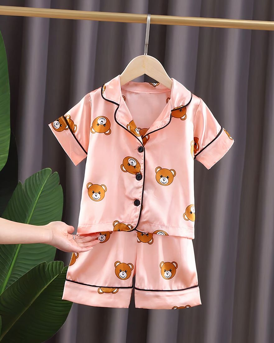 Pink cotton bear pajamas for kids on a belt in a house