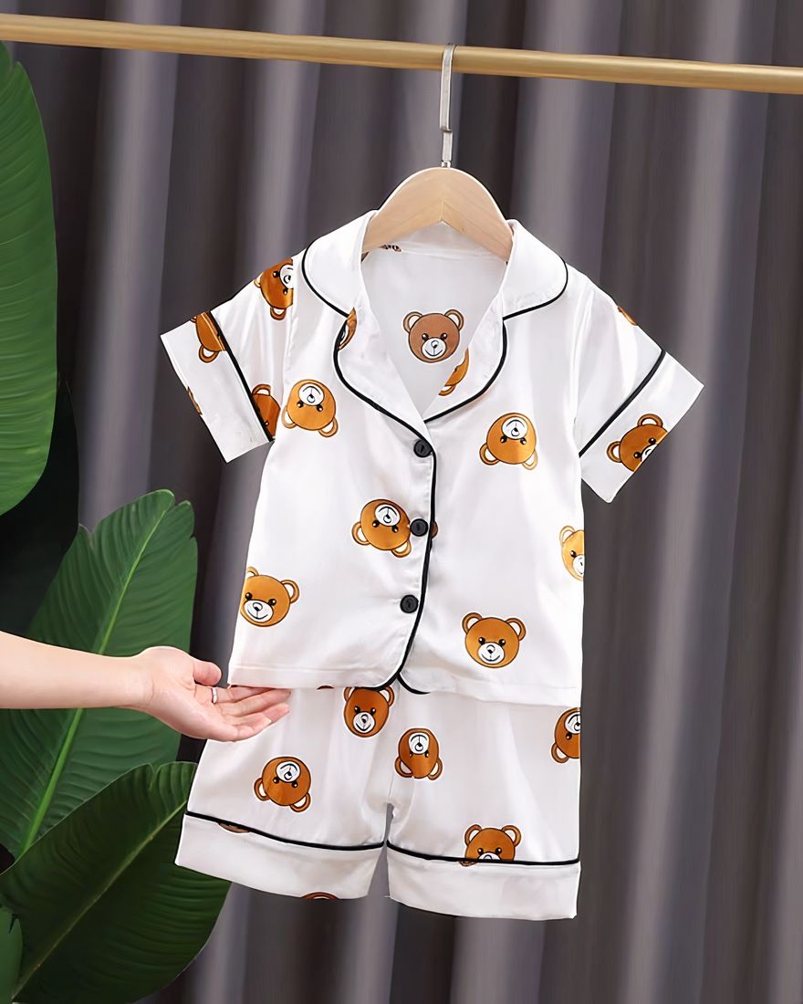 White cotton summer pajamas with bear pattern for children on a belt in a house