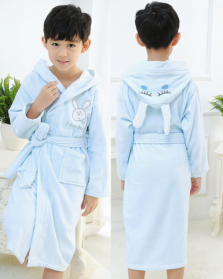 Blue cotton bunny pajamas for children worn by a little boy in a house