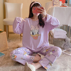 Daisy print long sleeve cotton pajamas with a girl wearing the pajamas and a dining room background