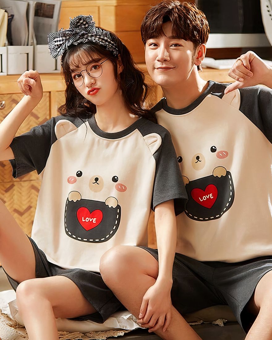 Two-piece cotton t-shirt and bear shorts worn by a couple sitting on a chair in a house
