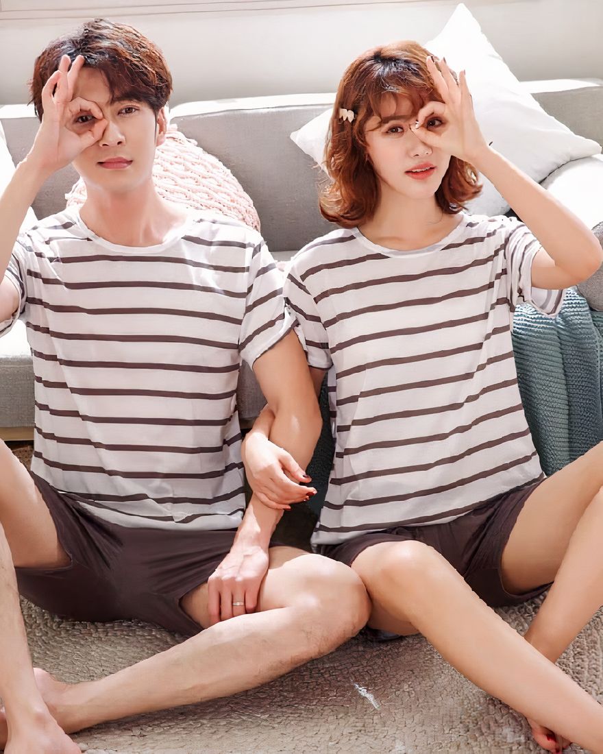 Two pieces pyjamas with brown striped white t-shirt and brown shorts very fashionable, worn by a couple in a house