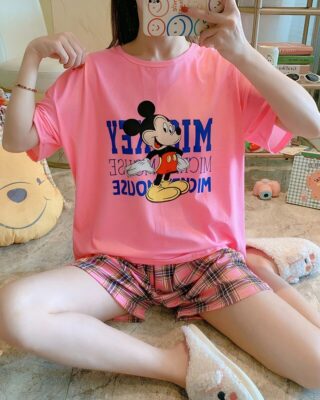 Pyjama t-shirt and pink shorts with Mickey plaid pattern worn by a woman in a house