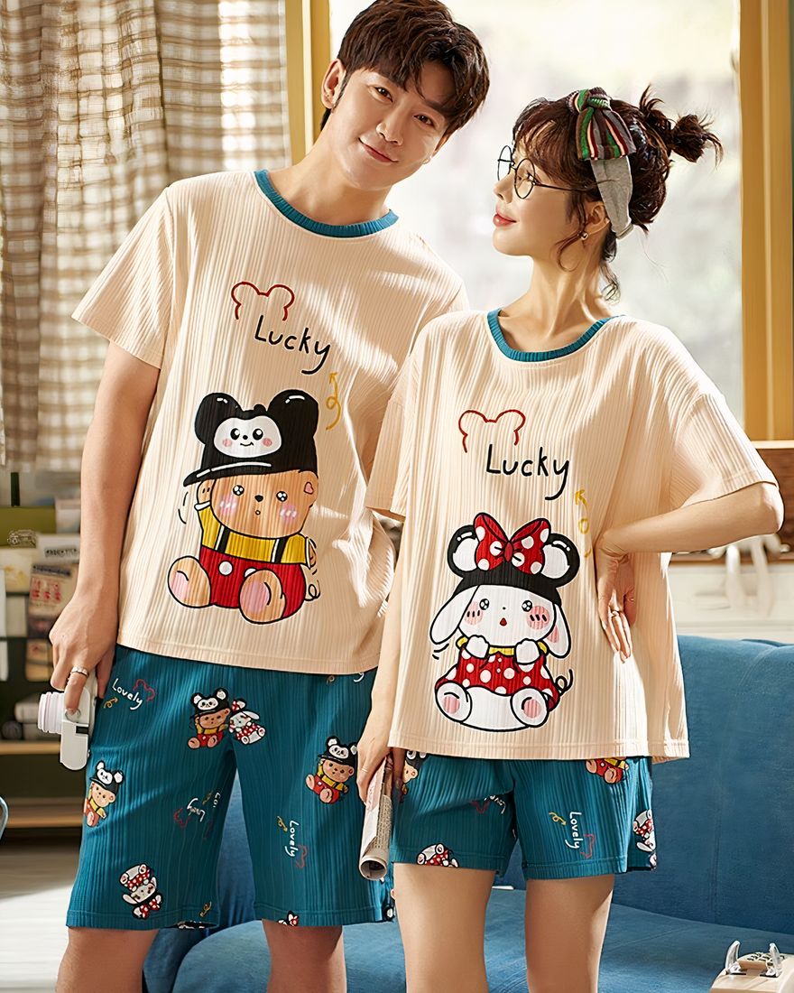Pyjama t-shirt and cotton shorts with cartoon pattern worn by a fashionable couple in a house