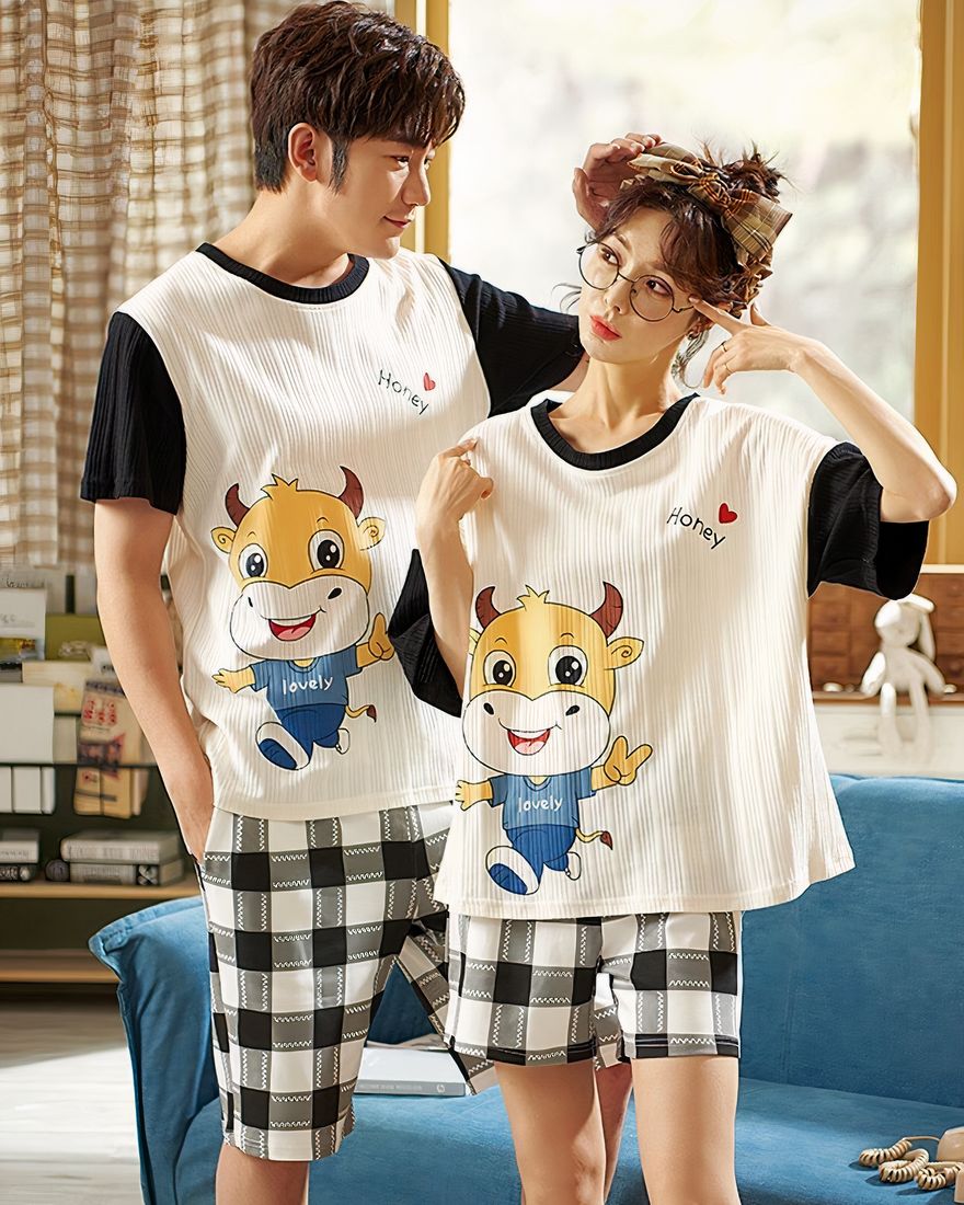 Pajama t-shirt with bull pattern and cotton plaid shorts worn by a couple in front of a chair in a house
