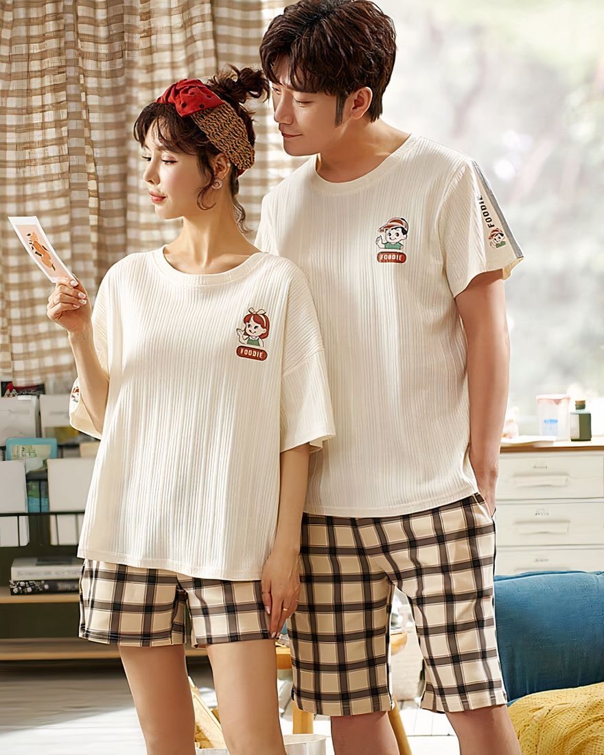 Off-white t-shirt pajamas and black and beige cotton shorts worn by a fashionable couple in a house