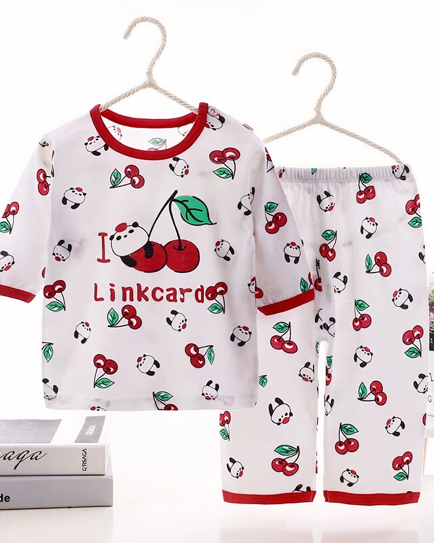 White summer pajamas in cotton with cherry pattern for kids on a belt in a house