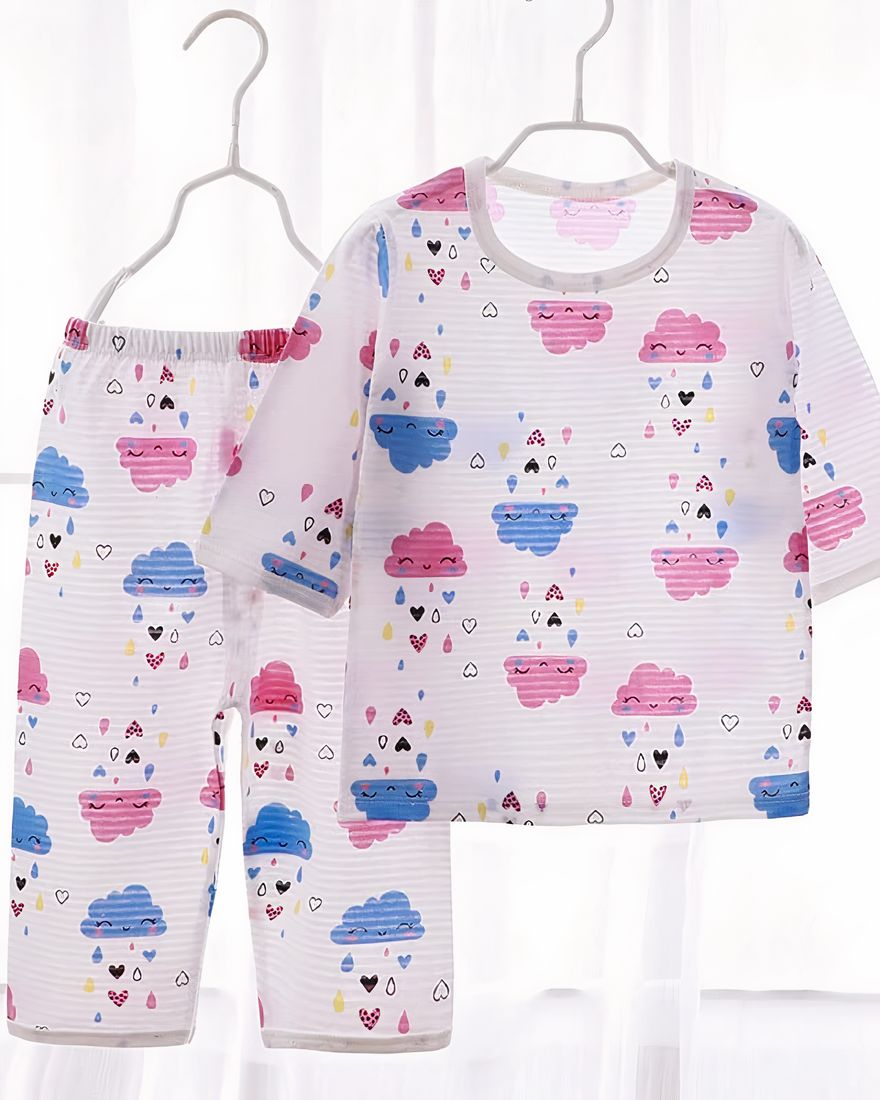 White cotton summer pajamas with clouds for children on a hanger in a house
