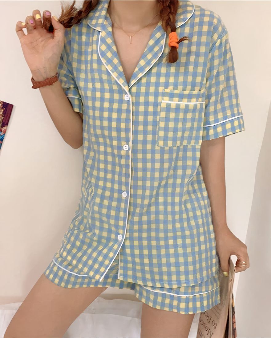 Short-sleeved blue-yellow checkered pajamas for women worn by a woman in a house