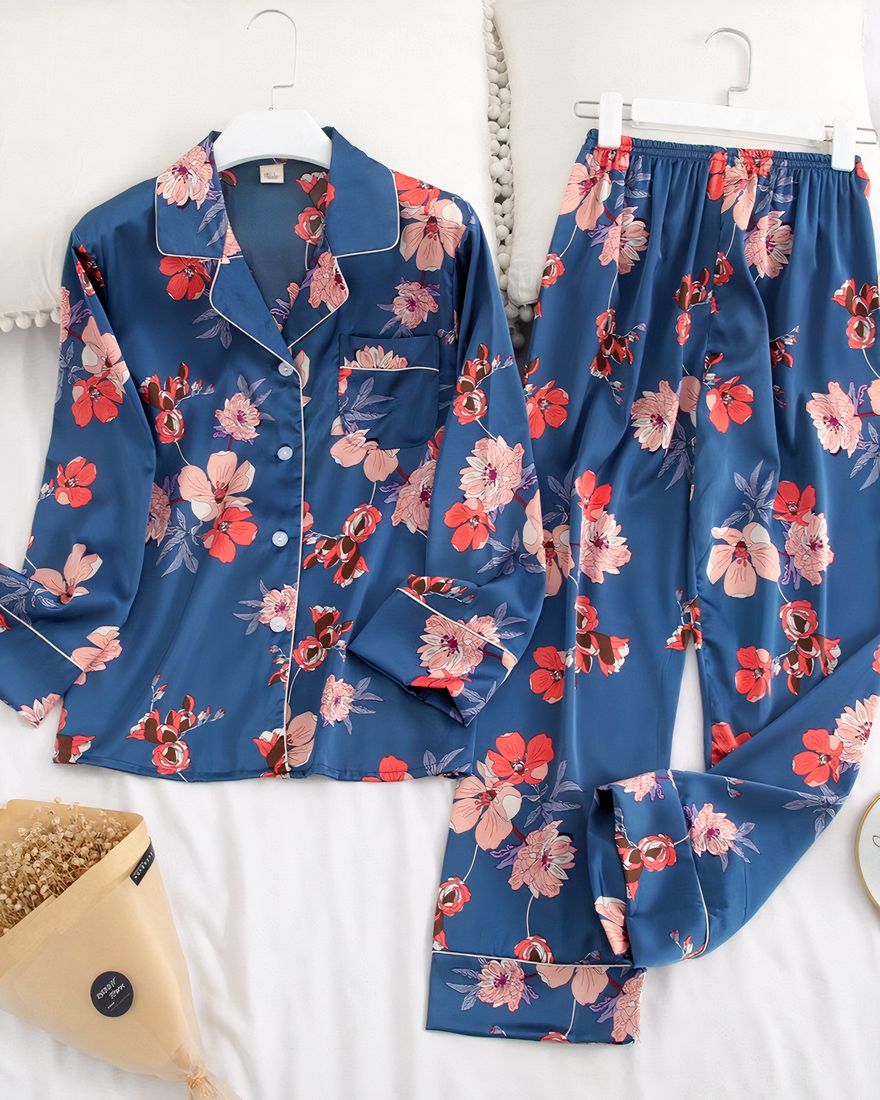 Two-piece blue pajamas with long sleeves and folded collar with a very fashionable floral pattern on a belt