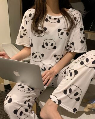 Two-piece pyjama short sleeves panda pattern white and black worn by a woman