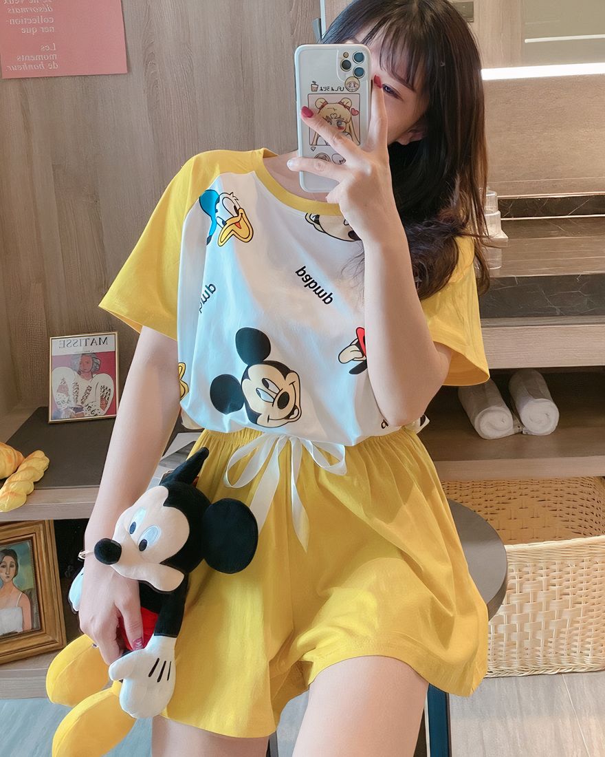 Yellow Mickey Donald print summer pajamas worn by a woman wearing a plush