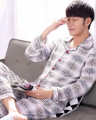 Cotton striped pajamas worn by a man sitting on a chair in a house