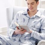 Blue feather pajamas worn by a man sitting on a chair in a house