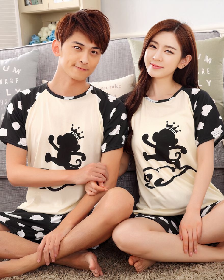 Monkey pattern nightwear worn by a couple sitting in front of a sofa in a house