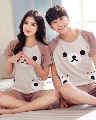 Pink couple's pajamas with bear pattern worn by a couple in a house