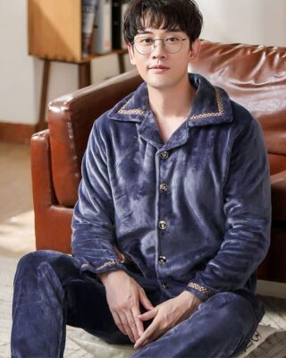 Plain grey flannel pajamas for men worn by a man in front of a sofa in a house