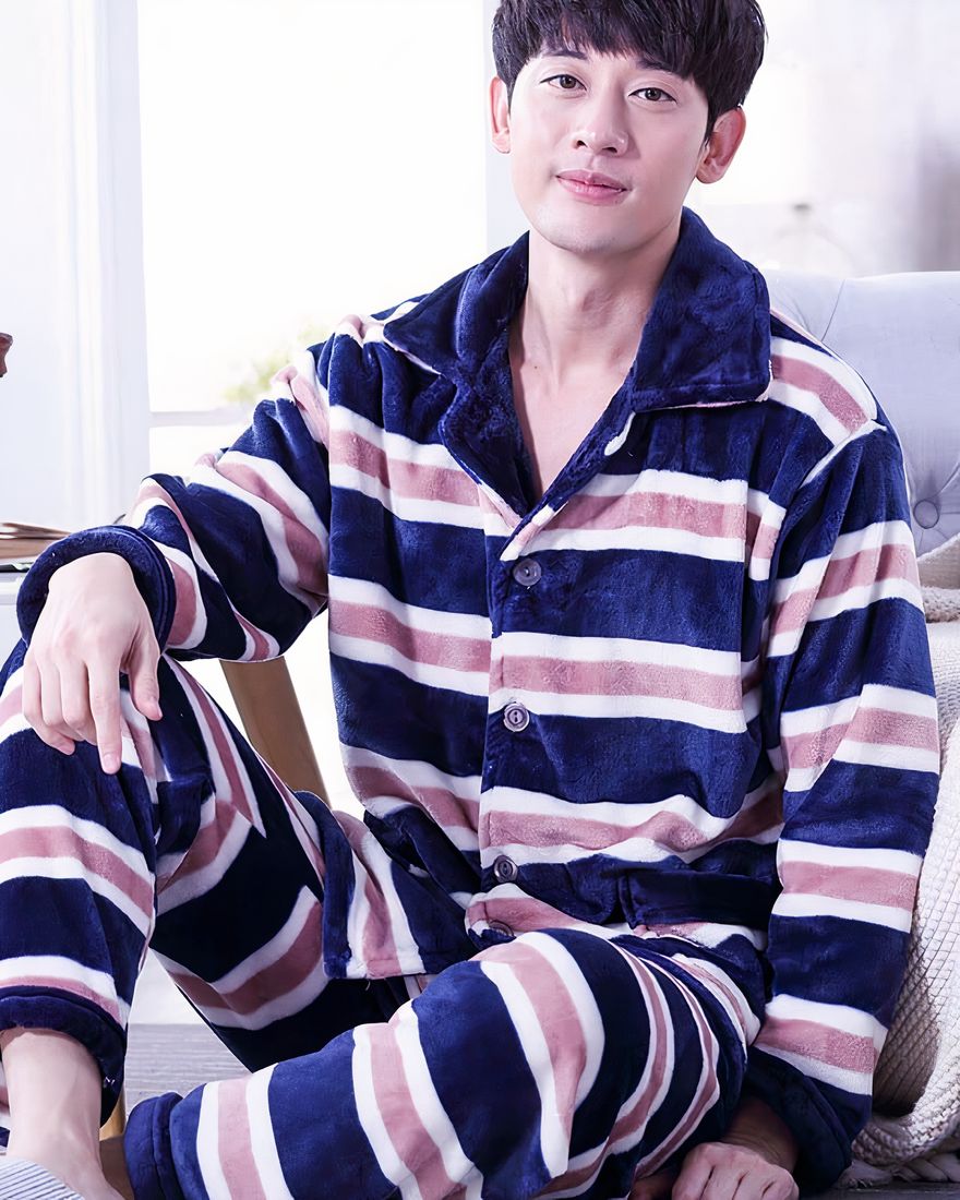 Striped lined pajamas for men worn by a man in front of a sofa in a house
