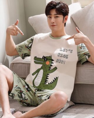 Short sleeve summer outfit with crocodile pattern worn by a man sitting on a carpet in a house