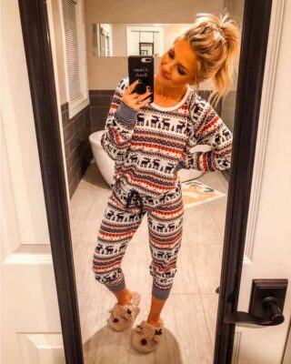 Christmas pajamas with reindeers for women worn by a woman who takes a picture in a mirror very fashionable