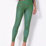 Green stripes Christmas leggings for women worn by a fashionable woman