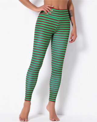 Green stripes Christmas leggings for women worn by a fashionable woman