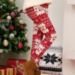 White and Red Christmas print leggings for women worn by a woman in a house