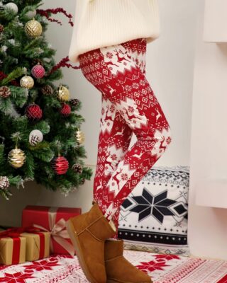 White and Red Christmas print leggings for women worn by a woman in a house