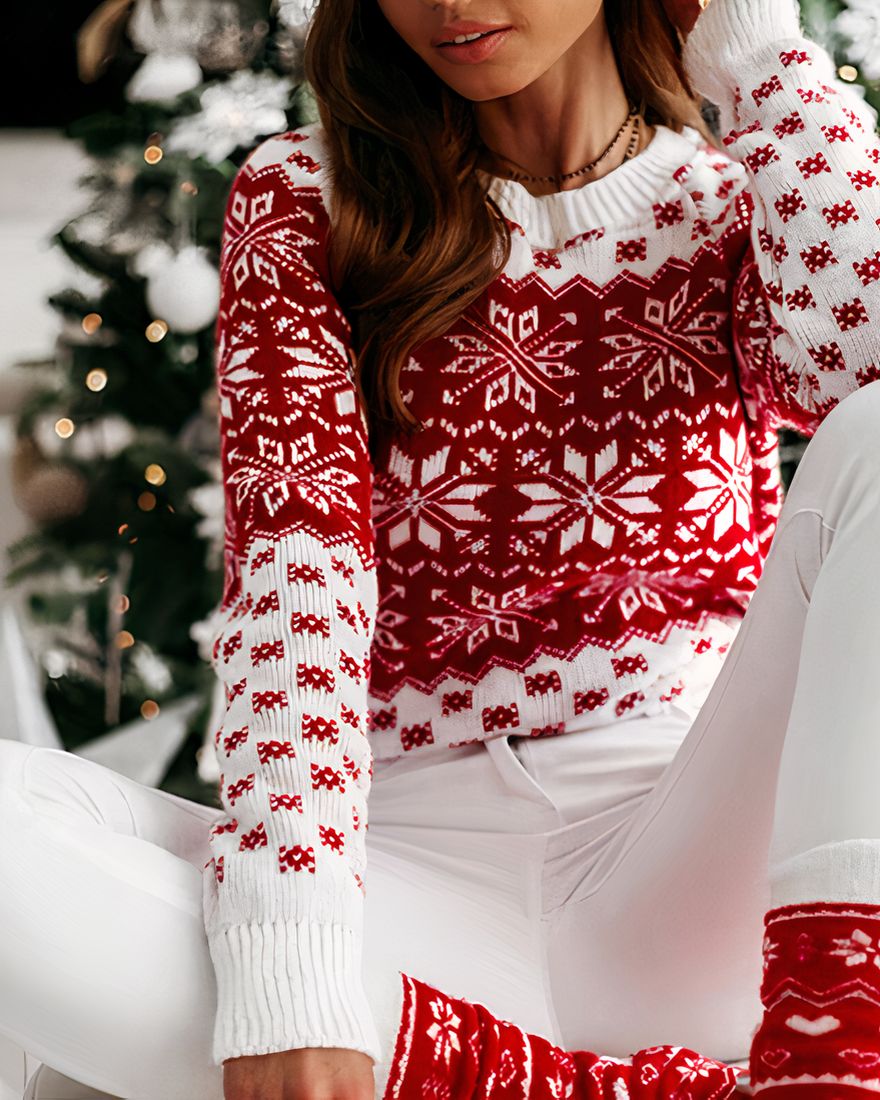 Christmas sweater with snowflake patterns for women worn by a woman sitting in front of a Christmas tree in a house