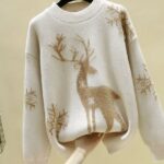 Women's knitted wool sweater with high quality Christmas reindeer on a hanger in a house