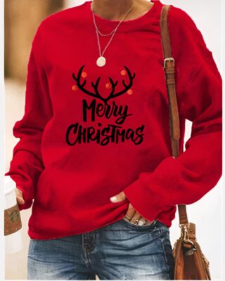 Long sleeve round neck sweater for women in red with unicorn design "Merry christmas" worn by a fashionable woman