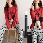 Women's Mickey pajama set worn by a woman wearing a headband sitting on a chair in a house