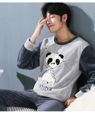 Pajamas with Panda pattern for men worn by a man sitting on a sofa in a house