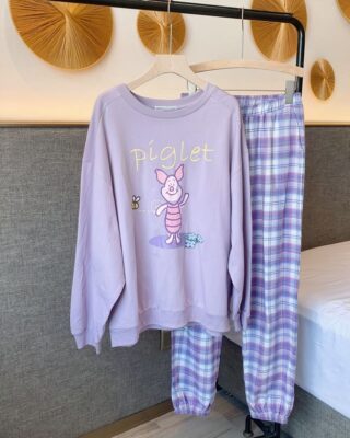 Piglet pajamas with purple checkered pants for woman on a belt in a house