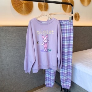Piglet pajamas with purple checkered pants for woman on a belt in a house