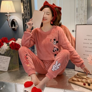 Pink Mickey pajamas for women worn by a woman wearing a red headband in a fashionable house