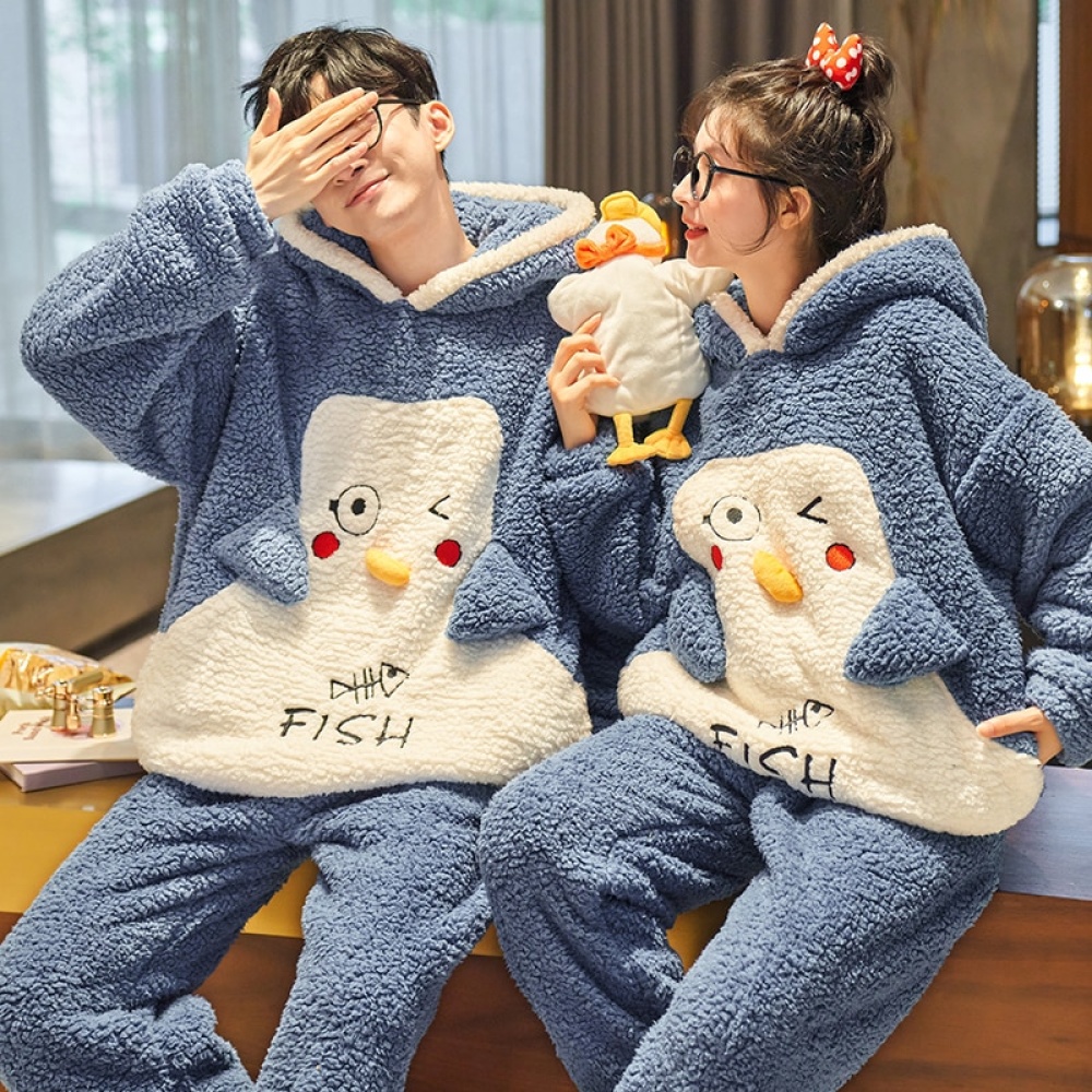 Funny blue and white polar pyjamas for couple worn by a couple in a house