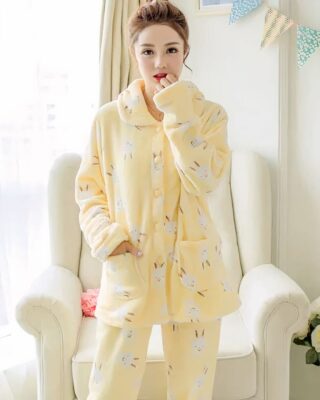 Winter pajamas long sleeves yellow rabbit pattern very comfortable worn by a woman in front of a chair in a house