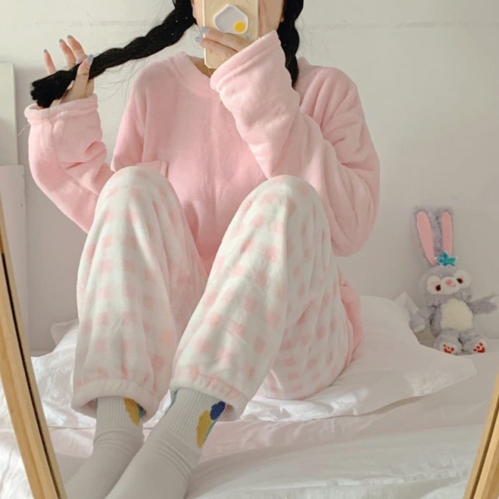 Women's soft winter pajamas candy color and pink and white striped pants worn by a woman taking a fashionable picture