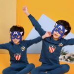 Spring blue two-piece pajamas for boys with two little boys wearing the pajamas with a superhero mask