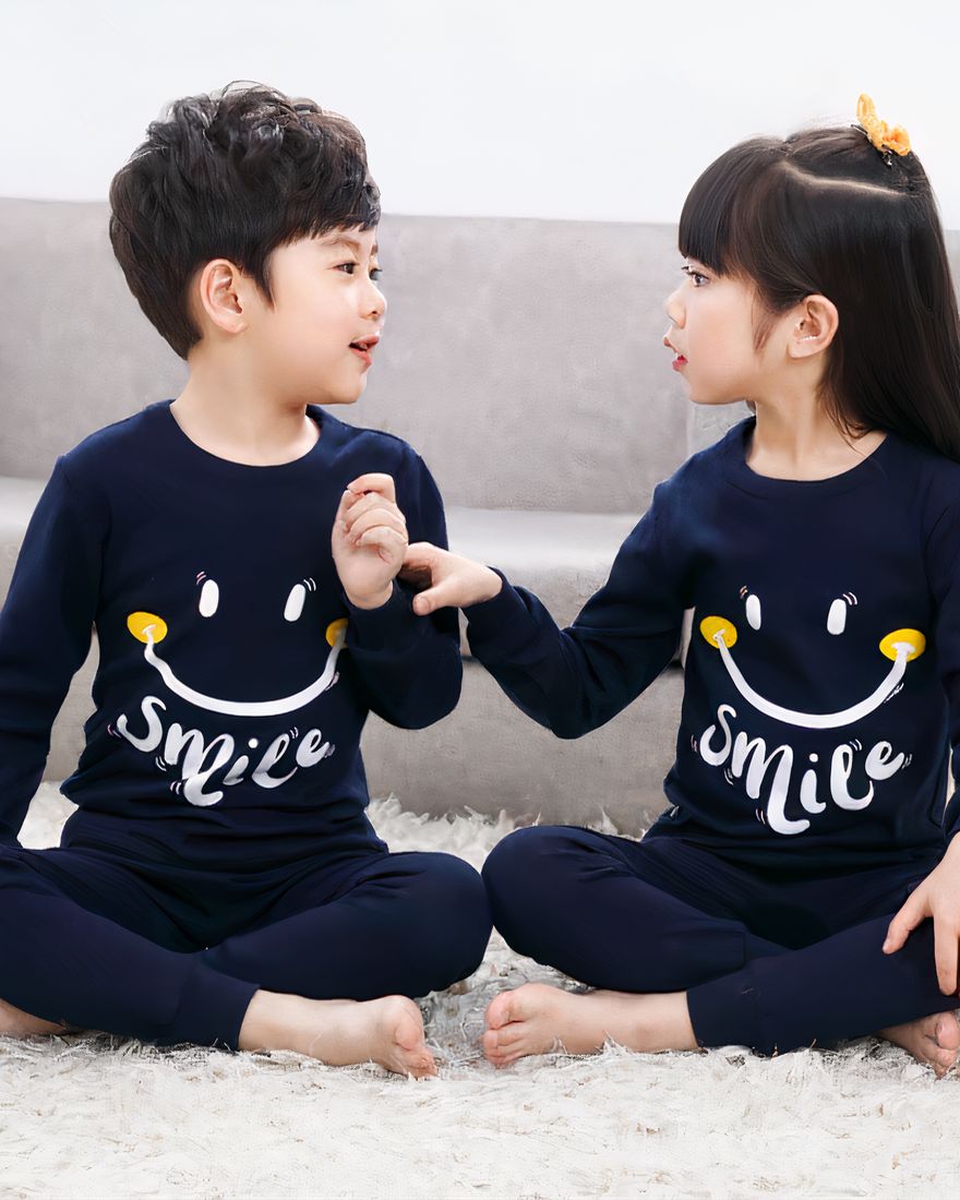 Smile patterned two-piece spring pajamas for children dark blue with two children wearing the pajamas