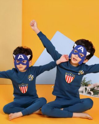 Spring blue two-piece pajamas for boys with two little boys wearing the pajamas with a superhero mask