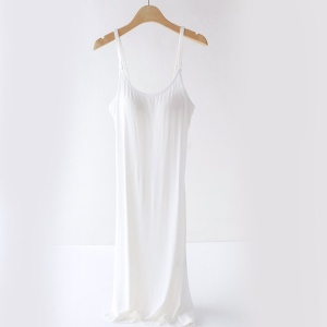 White pregnancy and nursing nightgown on a wooden hanger on a white background